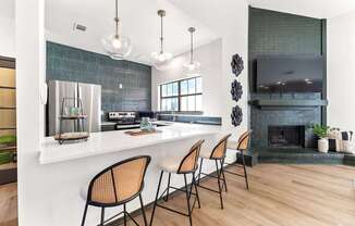 A kitchen with a bar area and a fireplace.