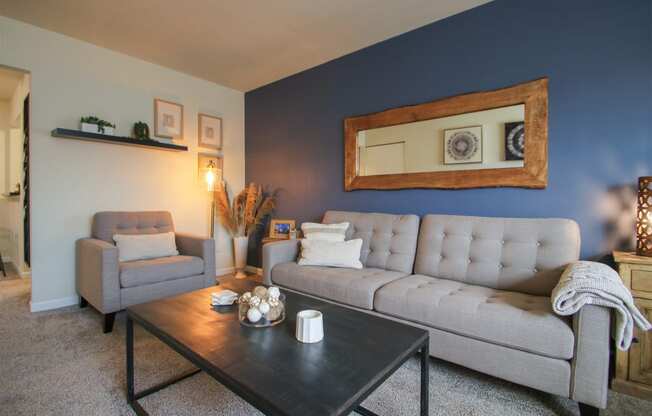 This is a photo of the living room of the 550 square foot 1 bedroom, 1 bath, balcony floor plan model apartment at College Woods Apartments in Cincinnati, OH.