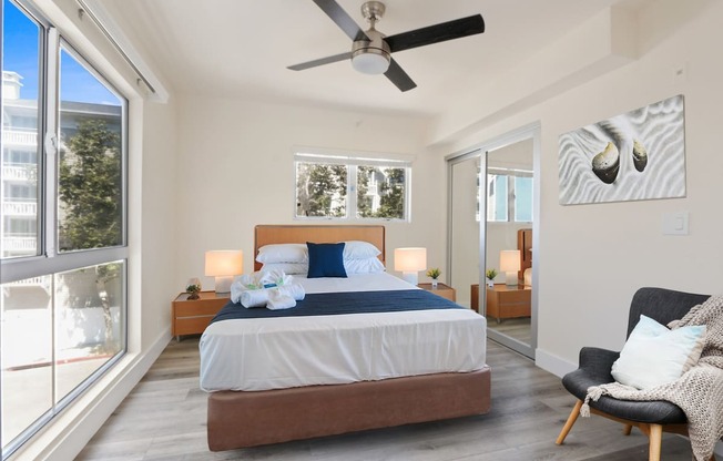 a bedroom with a bed and a ceiling fan