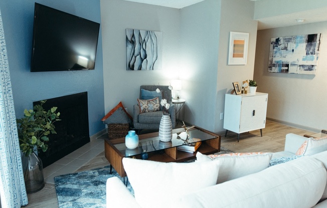 a living room with a white couch and a television