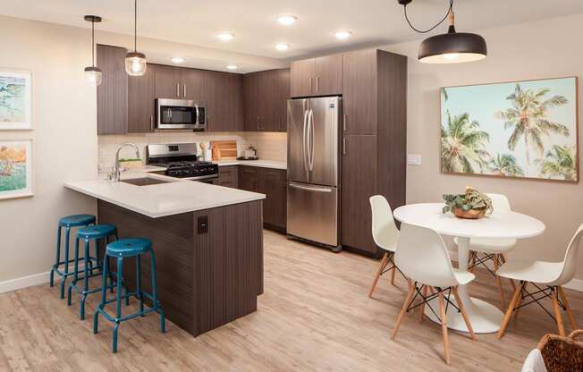 Kitchen with stainless steel appliances and dining area at Driftwood, San Diego, 92109