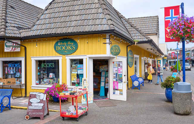 a yellow store with books on the side of a street at Woodcreek, Washington, 98370