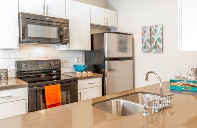 Kitchen With Stainless Steel Appliances at San Tropez Apartments & Townhomes, Utah