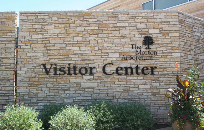 a brick building with a visitor center sign on it