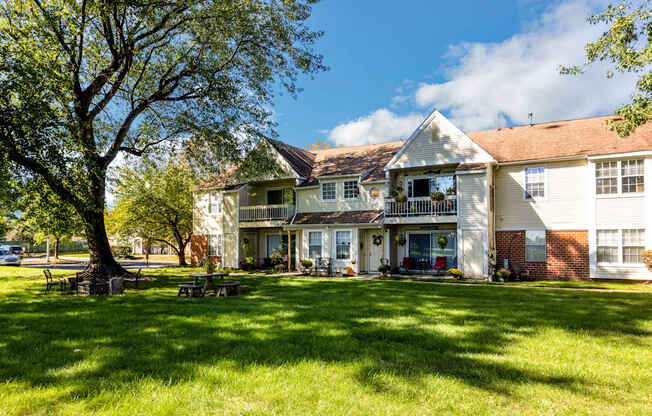 a large white house with a yard in front of it