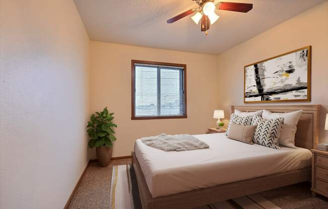 a bedroom with a large bed and a ceiling fan at France, Fargo, ND 58103