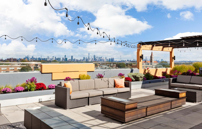 a rooftop patio with a view of the philadelphia skyline
