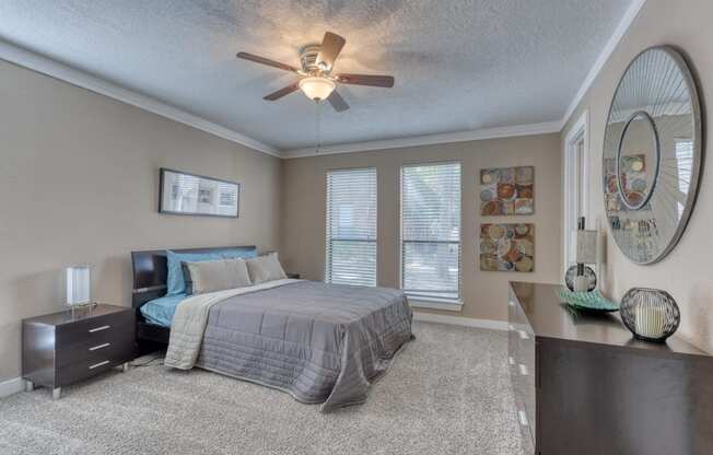 a bedroom with a bed and a ceiling fan
