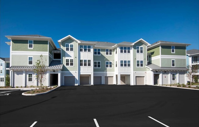 A row of modern houses with garages in front.