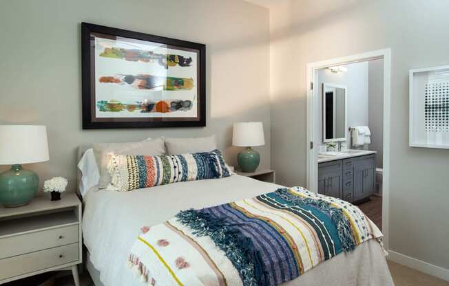 a bedroom with a large bed and a mirror at One Riverside Apartments, Chattanooga, 37403