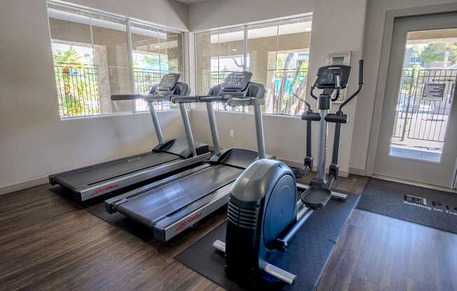 Treadmills and an elliptical machines in the gym.
