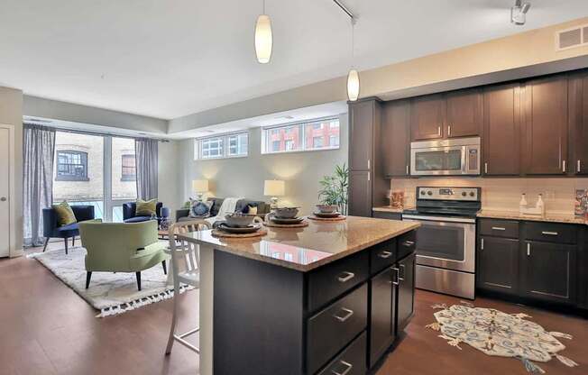 A modern kitchen with dark wood cabinets and a large island.