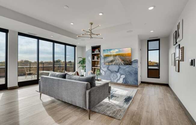 a living room with a couch and a wall of windows