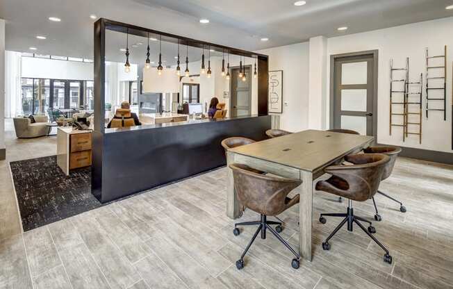 a conference room with a table and chairs and a kitchen at Arise Riverside, Texas