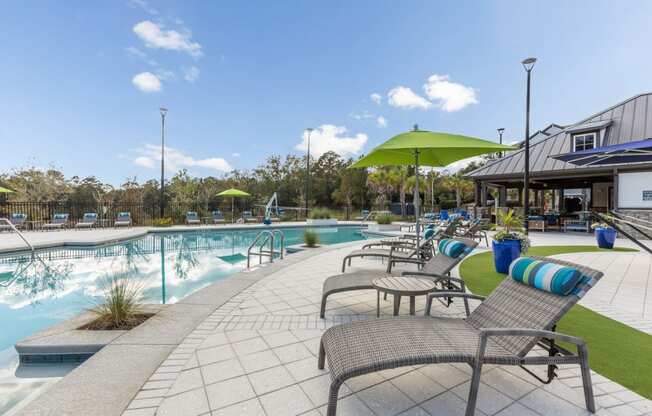 Poolside lounge chairs at Evergreen at Southwood in Tallahassee, FL