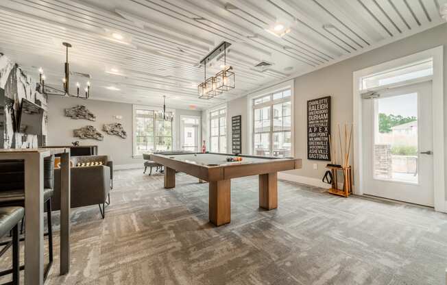 a game room with a pool table and a bar