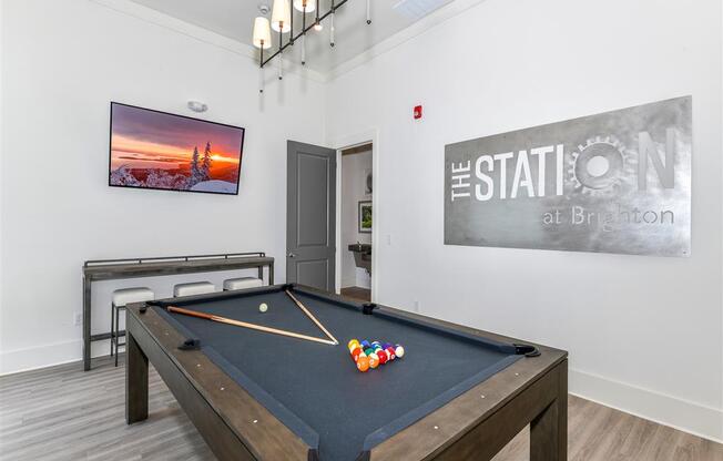Clubhouse with pool table and TV at The Station at Brighton apartments for rent
