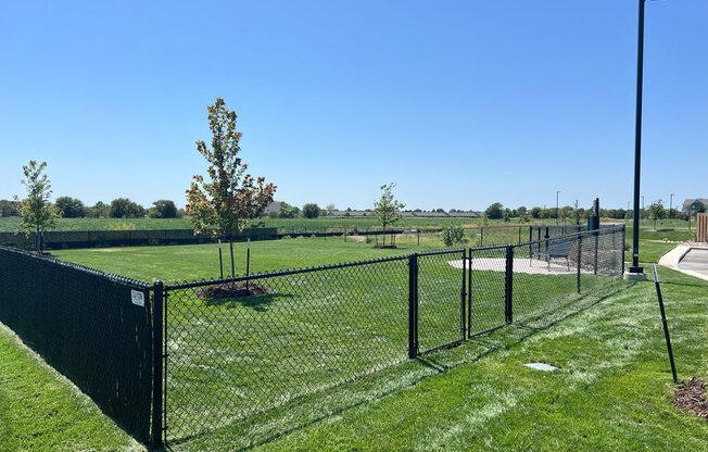 a spacious fenced in dog park at Copper Creek Apartments in Maize, KS