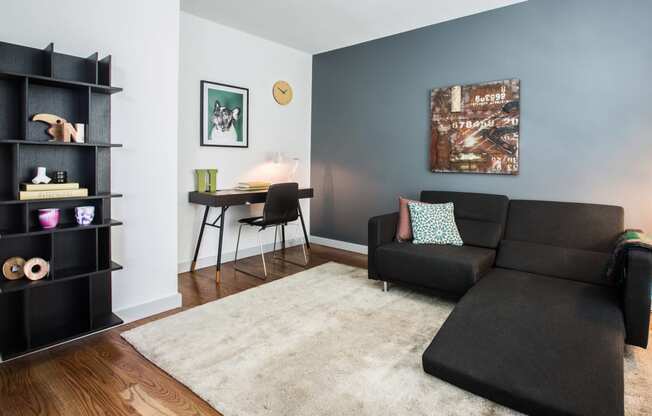 Model unit office room with hardwood floors and blue/grey accent wall