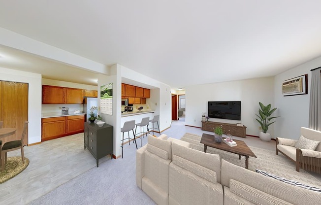 A living room with a couch, chairs, and a television.