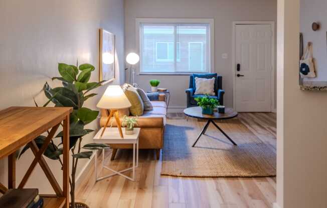 a living room with wooden floors and a couch and a table