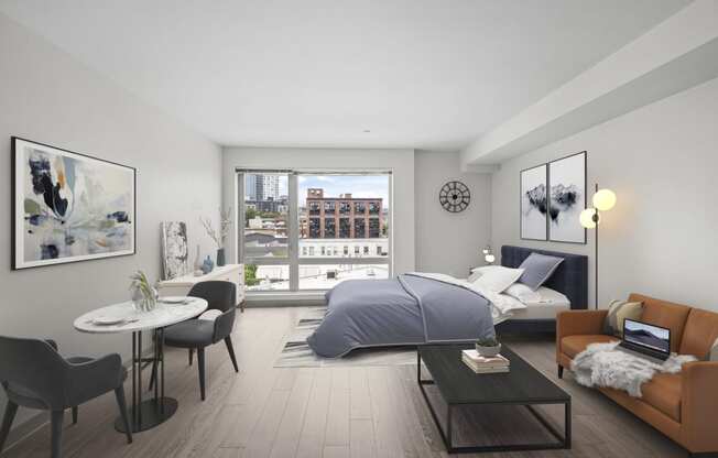 a bedroom with a bed and a living room with a table and chairs