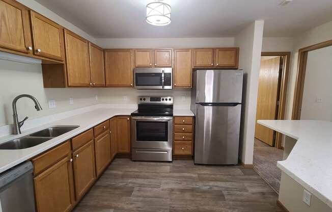 a kitchen with stainless steel appliances and wooden cabinets