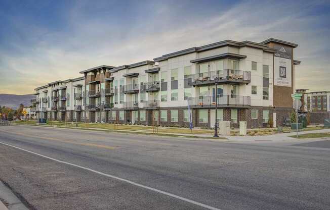 A street view of apartment buildings with a clear sky above.