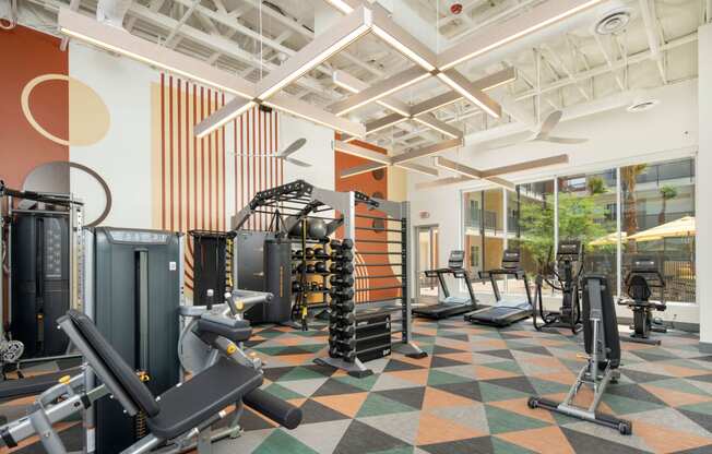 a view of the fitness center with a variety of exercise equipment