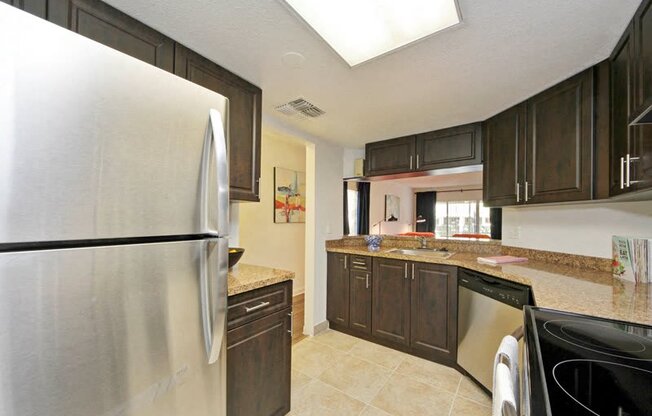 Kitchen with cabinets, stainless steel refrigerator, dishwasher, and oven