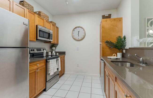 A kitchen with a refrigerator, microwave, and oven.
