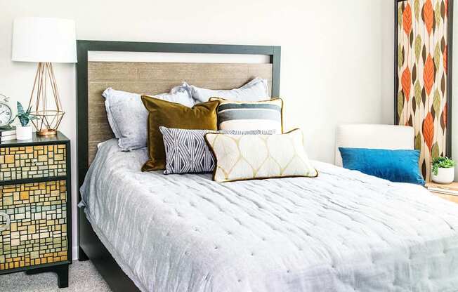 One-bedroom sleeping area flooded with natural light, showcasing a cozy atmosphere complemented by plush carpeting for ultimate comfort.