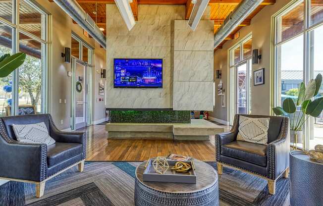 A living room with a flat screen TV mounted on the wall.