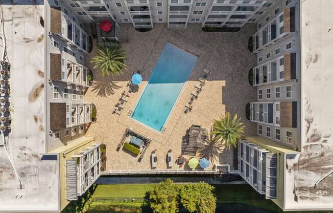 an aerial view of an apartment building with a swimming pool