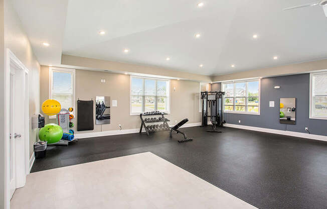 A fitness center with exercise equipment at Meadowbrooke Apartment Homes in Grand Rapids, MI 49512