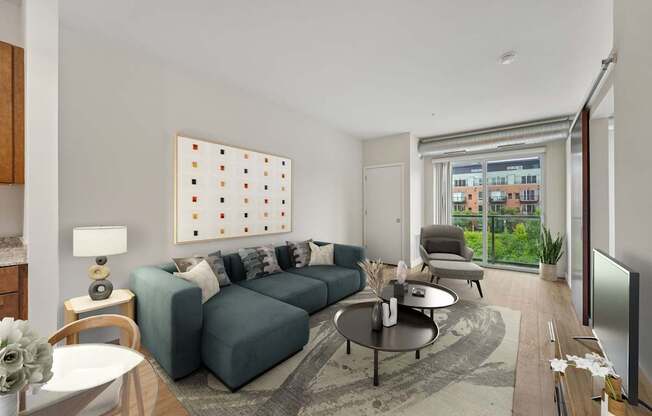 A living room with a grey sofa, a coffee table, a lamp, a painting, and a sliding glass door.