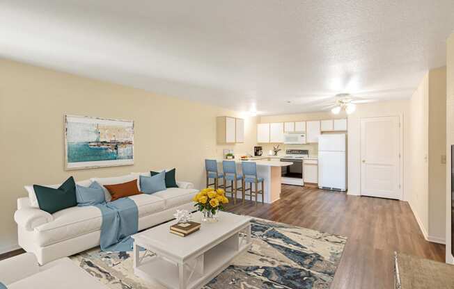 an open living room and kitchen with a white couch and table