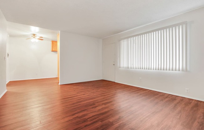 Living room with wood style floors throughout the kitchen