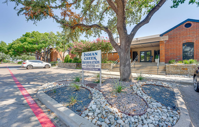 the creek neighborhood center sign in front of a tree