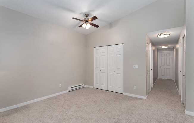 Novela Apartments Bedroom with Ceiling Fan and Closet Door