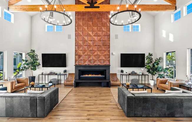 A modern living room with a fireplace and two TVs.