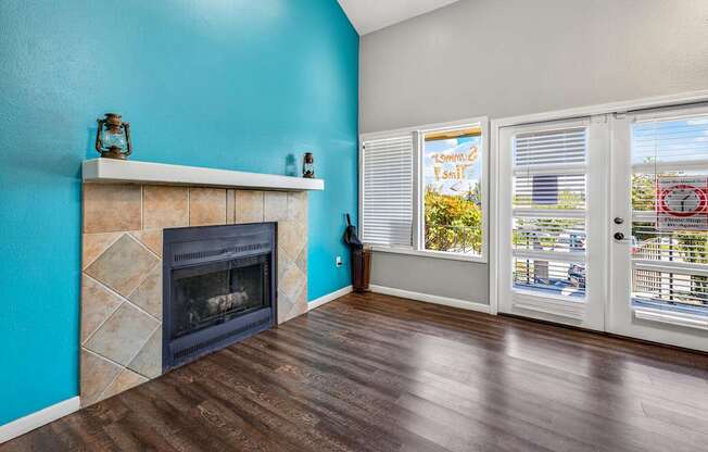 A room with a fireplace and a window with blinds.