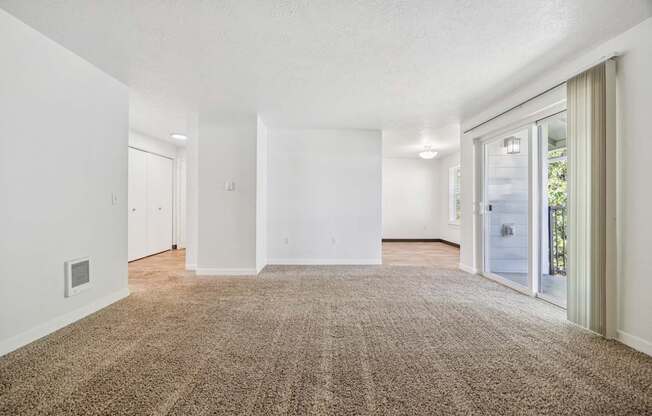 A room with a carpeted floor and white walls.
