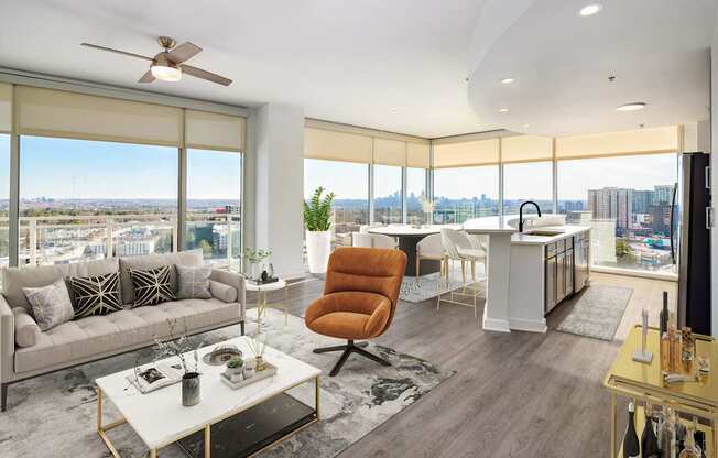 an open living room and kitchen with a view of the city
