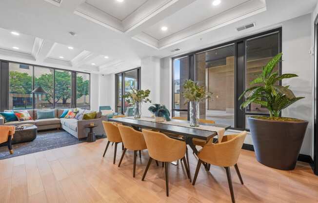 a dining area with a table and chairs and a living room with a couch
