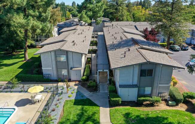 Ariel shot above the community overlooking the buildings, walk paths and community swimming pool. at Renaissance Park Apartments, California, 95618