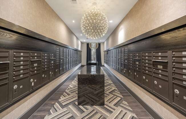 a long hallway filled with wine lockers and a large chandelier