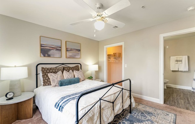 a bedroom with a large bed and a ceiling fan