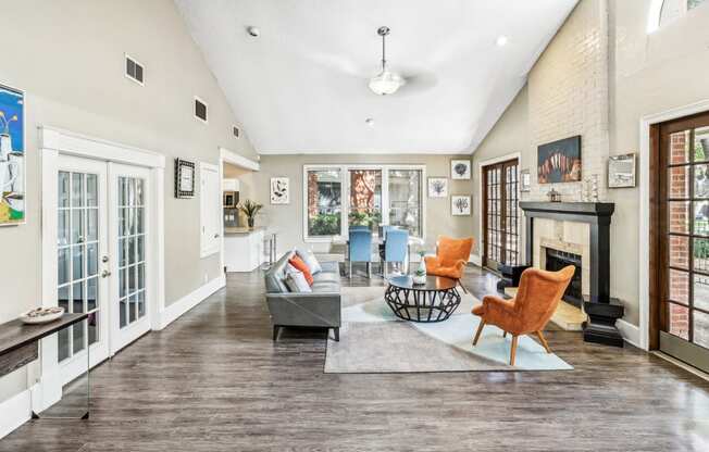 Leasing office lounge area with couch and a fireplace at Hunters Chase Apartments in Austin, TX