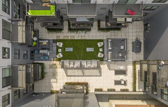 an overhead view of a building with a courtyard and a lawn